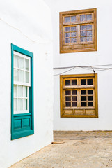 Fototapeta na wymiar Green window of typical white house. Lanzarote. Canary Islands. Spain
