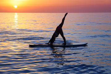 Doing yoga on the beach