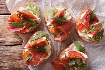 sandwich with figs, ham and cream cheese close-up. Horizontal top view
