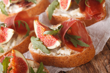homemade sandwiches with figs, ham, arugula and cream cheese close-up. horizontal
