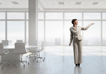 Fototapeta premium Businesswoman in office . Mixed media