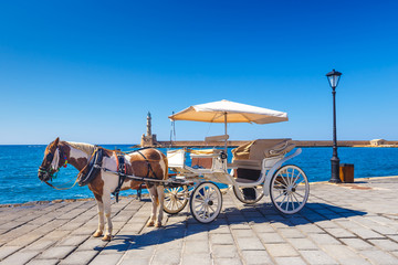 Horse carriage for transporting tourists in old port of Chania on Crete, Greece