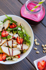 Strawberries salad with pine nuts, arugula and chicken. Beet  fresh juice. Healthy & fitness food. top view