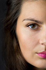 Fototapeta premium Portrait close up half of face young beautiful woman