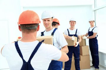 stevedores unload boxes in new premises