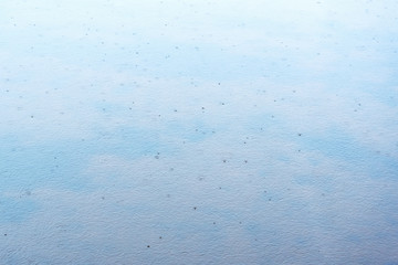 Rain on water surface.