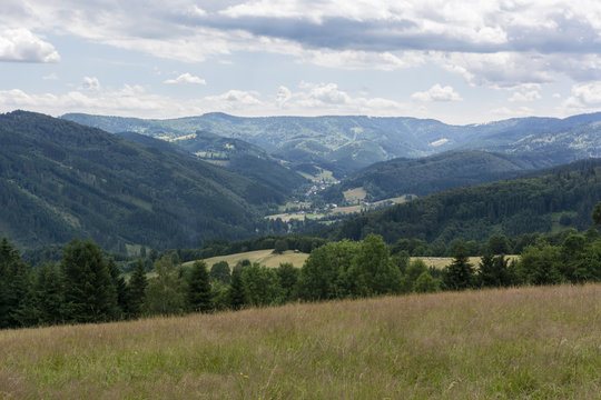 Fototapeta Mountain landscape with the town in the valley.
