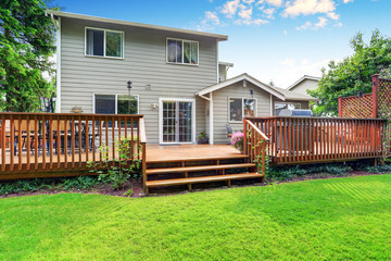 Back yard house exterior with spacious wooden deck - 118596987