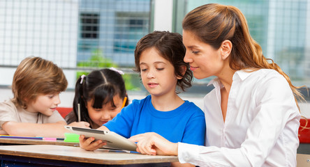 Multi ethnic classroom learning use of tablet