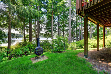 Backyard house with wooden trim and well kept lawn