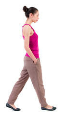 back view of walking  curly woman.  backside view of person.  Rear view people collection. Isolated over white background. dark girl goes with his hands in his pockets.