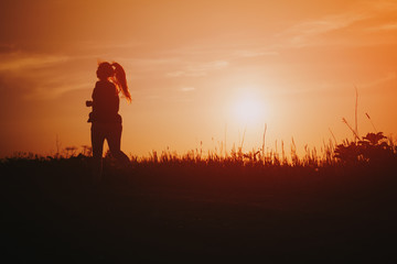 teenage girl runner countryside in sunset