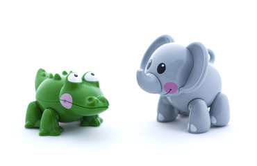 Toy crocodile and elephant on a white background