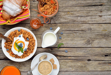 Ingredients for a healthy breakfast - granola,berries,yogurt and juice. Top view. Space for text.