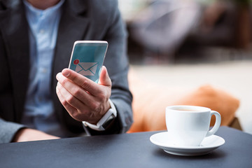 Pleasant man holding cell phone