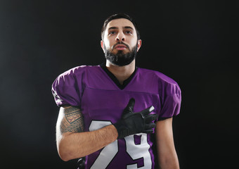 American football player on black background © Africa Studio