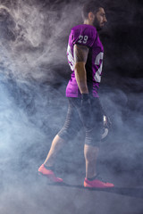 American football player on smoky background
