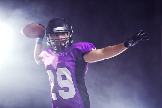 American football player on smoky background