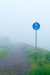 Traffic sign pedestrians and cyclists in fog