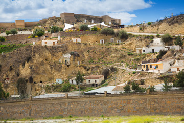 Fototapeta na wymiar Dwellings houses into rock at Puerto Lumbreras and castle