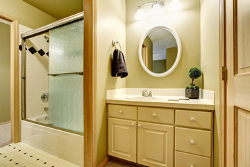 Bathroom interior in yellow tones with vanity cabinet