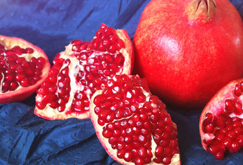 Juicy ripe pomegranates on dark background