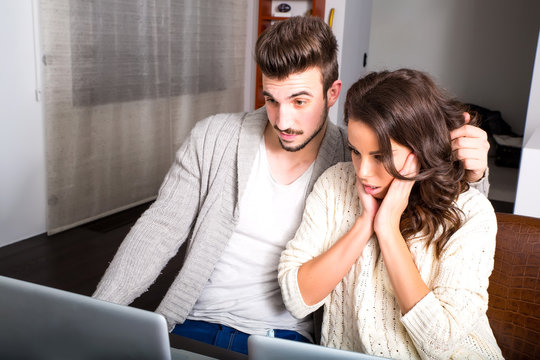 Young couple using a Tablet PC in the kitchen at home