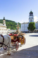 Naklejka na ściany i meble Horse-drawn carriage on the main market of Salzburg