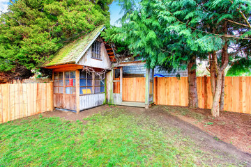 Back yard with wooden fence and barn shed.