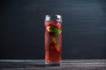 Raspberry cocktail with mint on the wooden background