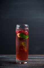 Raspberry cocktail with mint on the wooden background