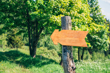 Wooden pointer on the mountains valley