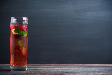 Raspberry cocktail with mint on the wooden background