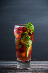 Raspberry cocktail with mint on the wooden background