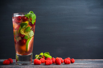 Raspberry cocktail with mint on the wooden background