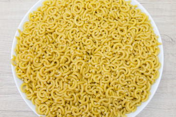 white bowl of fideuá on a wooden table
