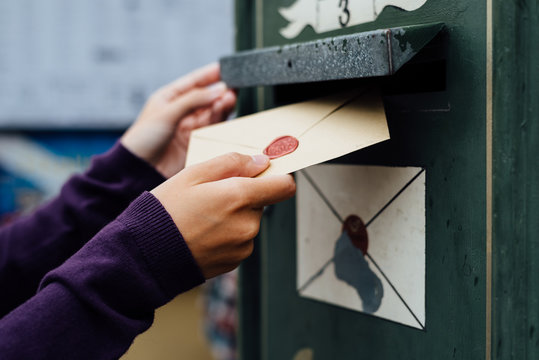 Posting Letter To Old Postbox On Street