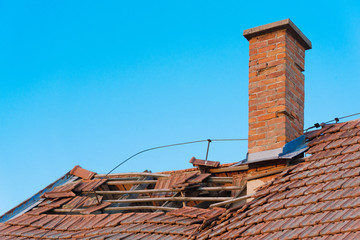 Brick chimney on old abandoned roof