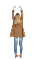 Back view of  woman.  Raised his fist up in victory sign.    Raised his fist up in victory sign.  Rear view people collection.  backside view of person.  Isolated over white background. The blonde in