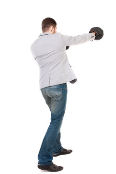 businessman with boxing gloves in fighting stance. Isolated over white background. Rear view people collection.  backside view of person. A guy in a gray jacket boxing gloves.
