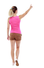 back view of pointing walking  woman. going girl pointing.  backside view of person.  Rear view people collection. Isolated over white background. Sport blond in brown shorts goes back frame pointing
