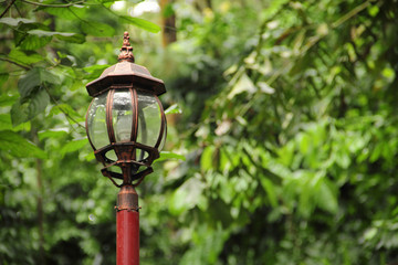 Vintage lamp post over greenery