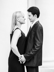 Couple hugging near the pillars of the old manor