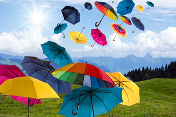 Happiness, lust for life: flying colorful umbrellas on in front of blue sky :) - obrazy, fototapety, plakaty