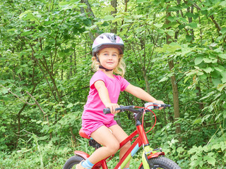 Happy child riding a bike in outdoor.