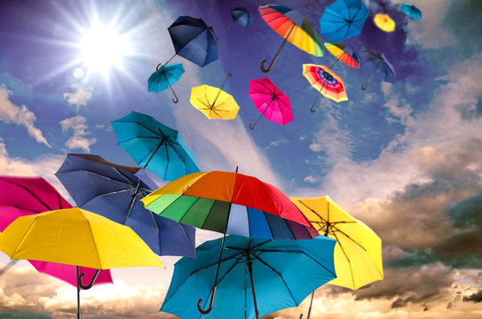 Happiness, lust for life: flying colorful umbrellas on in front of blue sky :)