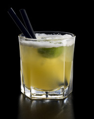 homemade cold lemonade with lime and ice cubes in glass