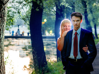Couple hugging on the background of the pond in the park