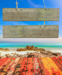 vintage wooden signboard with blank space for insert texts at the beautiful beach.