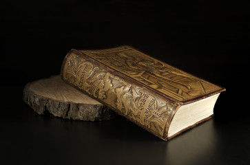 Miguel de Cervantes - Detail Old Embossed Leather Book Edition of The Ingenious Gentleman Don Quixote of La Mancha, Isolated on Dark Background